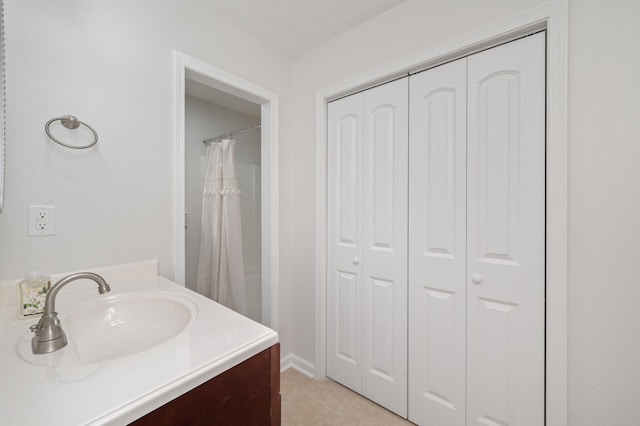 full bath with tile patterned flooring, a closet, and vanity