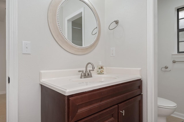 bathroom featuring toilet and vanity