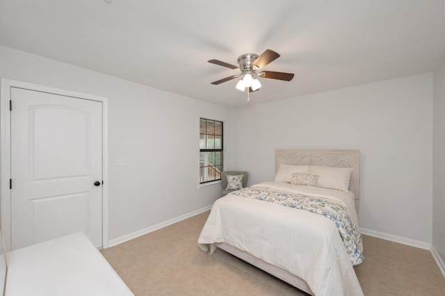 bedroom featuring ceiling fan and baseboards