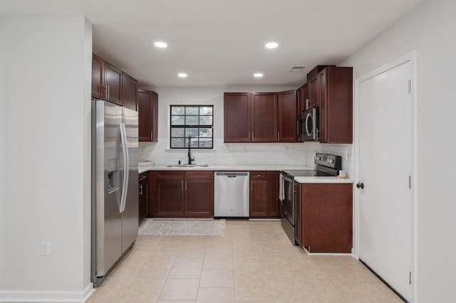 kitchen with visible vents, appliances with stainless steel finishes, backsplash, and a sink
