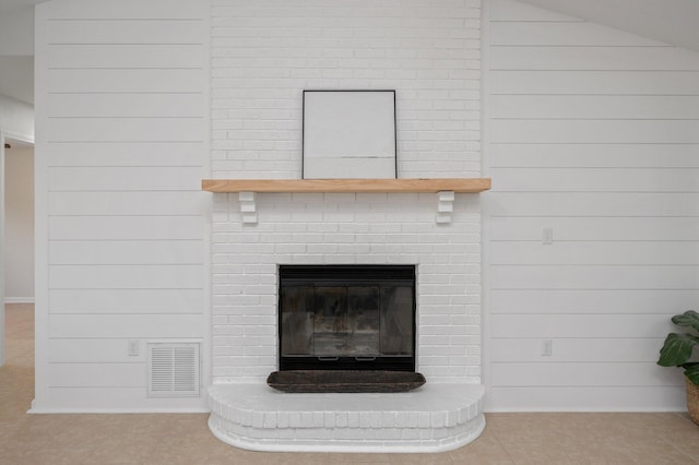 details featuring a fireplace, visible vents, and wooden walls