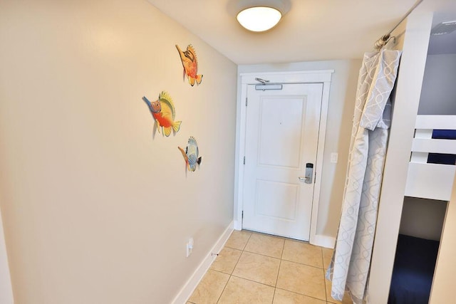 doorway with light tile patterned floors