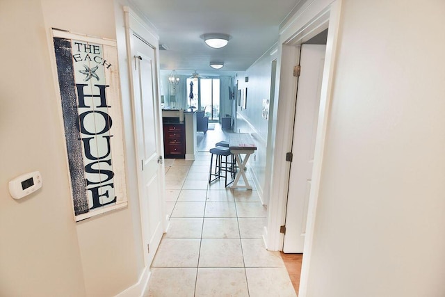 hall with light tile patterned floors