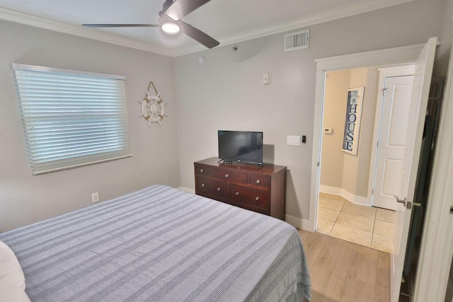 bedroom with ornamental molding, ceiling fan, and light wood-type flooring