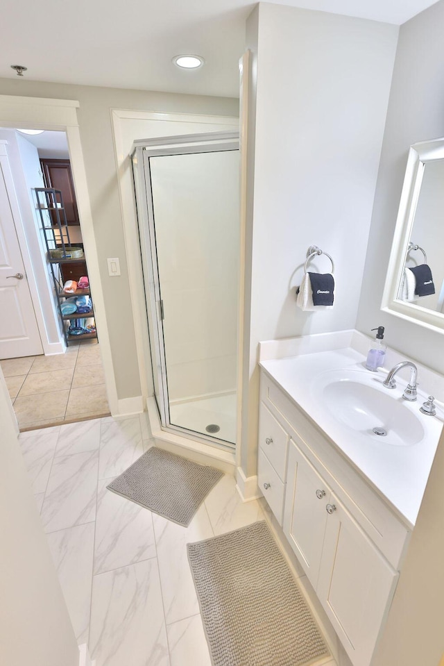 bathroom with vanity and a shower with door