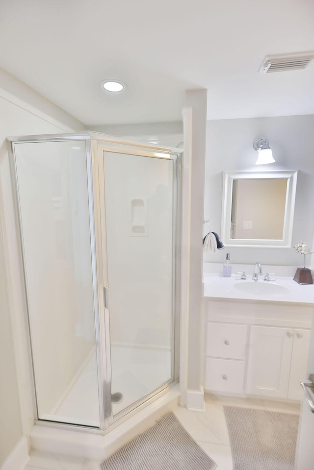 bathroom featuring vanity, tile patterned flooring, and a shower with shower door