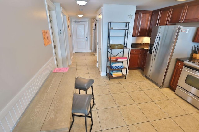 kitchen featuring stainless steel range and light tile patterned floors