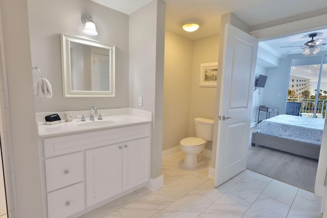 bathroom with vanity, ceiling fan, and toilet