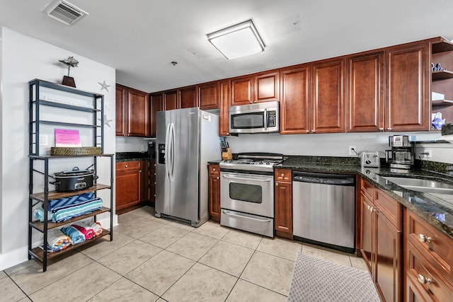 1110 Santa Rosa Blvd Unit C601, Fort Walton Beach, FL 32548 - kitchen featuring dark stone countertops, visible vents, open shelves, light tile patterned flooring, and stainless steel appliances