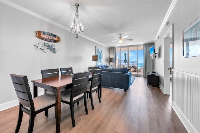 1110 Santa Rosa Blvd Unit C601, Fort Walton Beach, FL 32548 - dining room with light wood-type flooring, ornamental molding, ceiling fan with notable chandelier, expansive windows, and baseboards