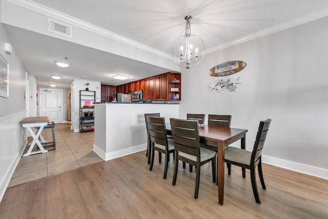 1110 Santa Rosa Blvd Unit C601, Fort Walton Beach, FL 32548 - dining room featuring light wood-style floors, visible vents, a notable chandelier, and crown molding