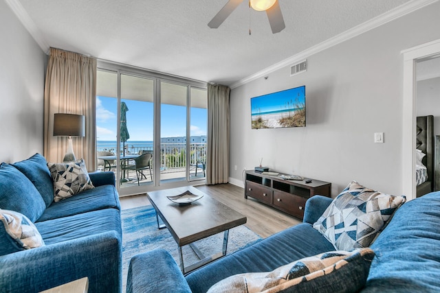 1110 Santa Rosa Blvd Unit C601, Fort Walton Beach, FL 32548 - living area featuring visible vents, a ceiling fan, wood finished floors, floor to ceiling windows, and crown molding