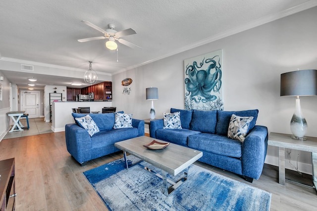 1110 Santa Rosa Blvd Unit C601, Fort Walton Beach, FL 32548 - living room with light wood-style floors, ceiling fan with notable chandelier, visible vents, and ornamental molding