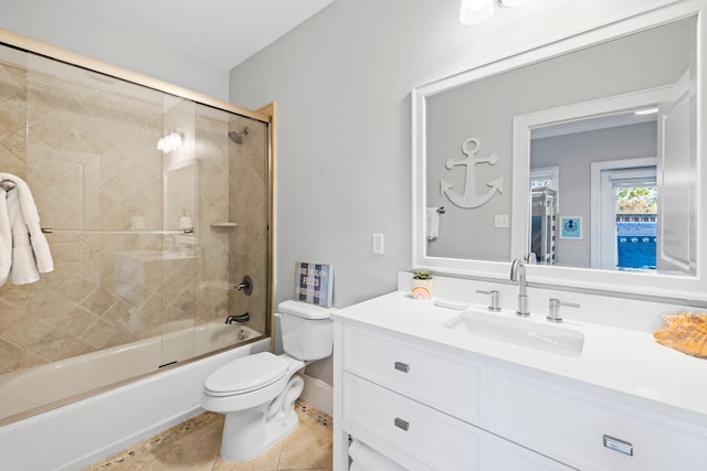 full bathroom with vanity, combined bath / shower with glass door, tile patterned floors, and toilet