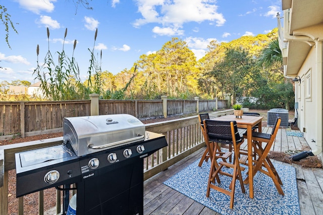 wooden deck featuring a grill and central AC unit