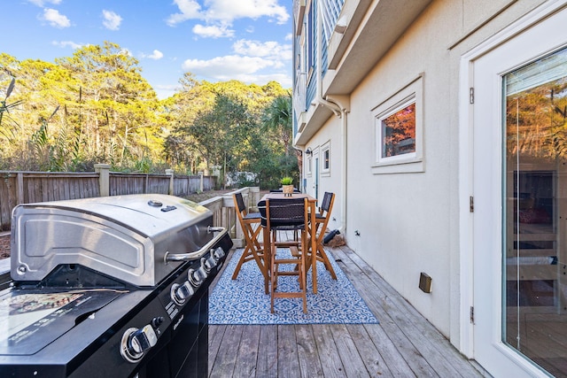 wooden terrace featuring grilling area