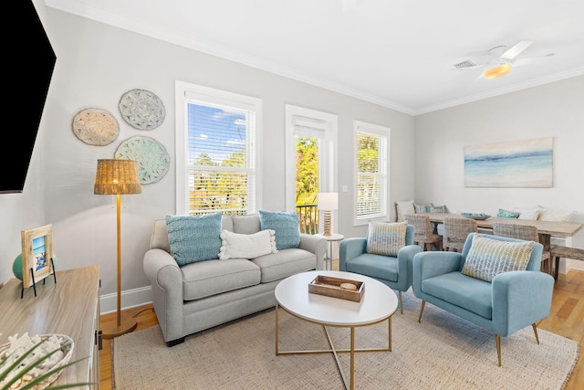 living room featuring crown molding and light hardwood / wood-style floors