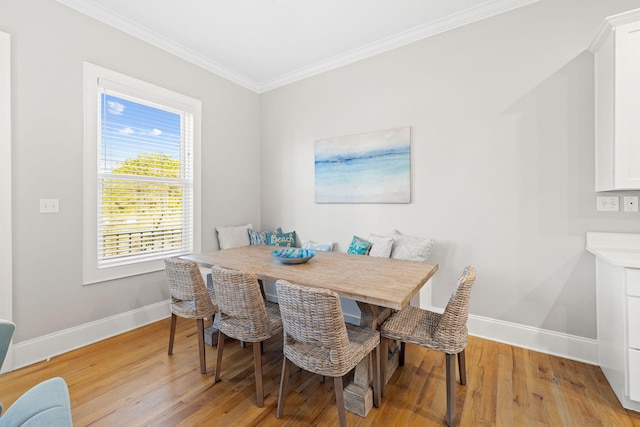 dining area featuring breakfast area, crown molding, and light hardwood / wood-style flooring