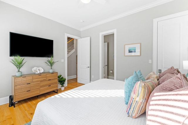 bedroom featuring wood-type flooring, ceiling fan, and crown molding