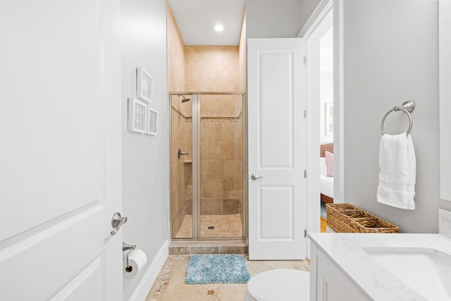 bathroom featuring vanity, an enclosed shower, tile patterned floors, and toilet