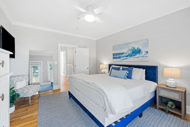 bedroom featuring hardwood / wood-style flooring, crown molding, and ceiling fan