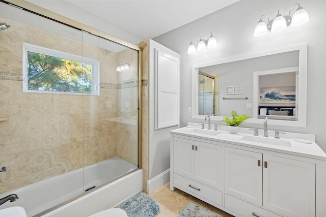 bathroom with vanity, tile patterned flooring, and bath / shower combo with glass door