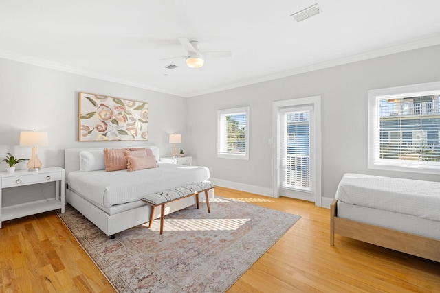 bedroom featuring crown molding, hardwood / wood-style floors, and ceiling fan