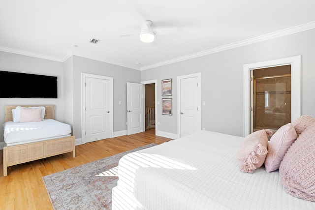 bedroom featuring hardwood / wood-style floors, ornamental molding, ceiling fan, and ensuite bathroom