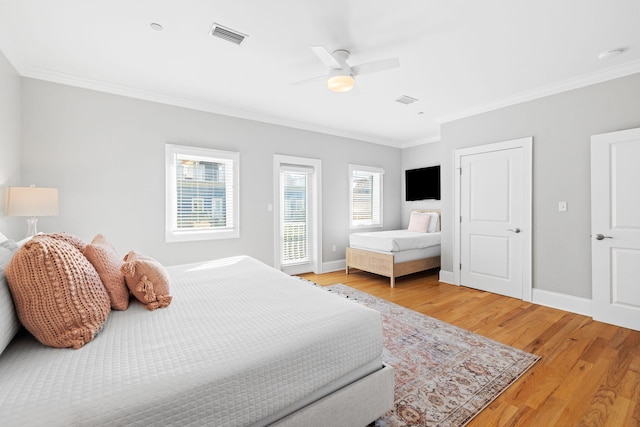 bedroom featuring hardwood / wood-style flooring, ceiling fan, and ornamental molding