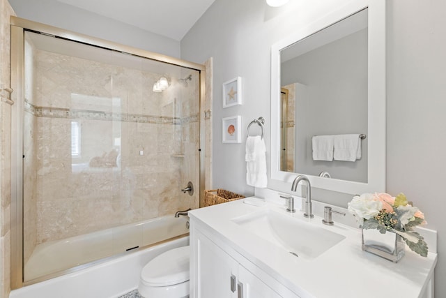 full bathroom with toilet, vanity, and shower / bath combination with glass door