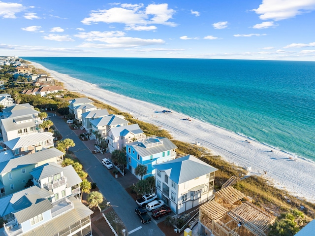 birds eye view of property with a view of the beach and a water view