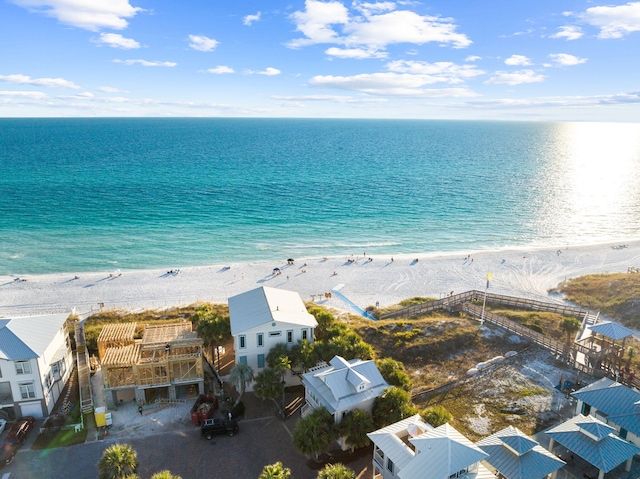 aerial view with a water view and a beach view