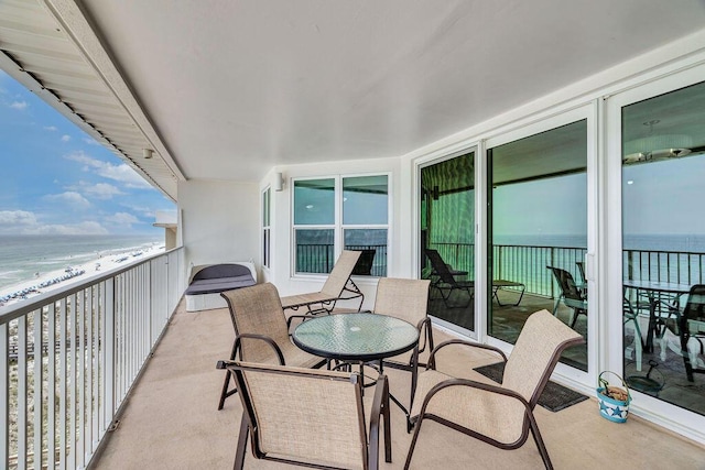 balcony with a beach view and a water view