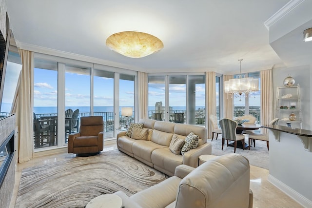 living area with a water view, a chandelier, a wall of windows, and a wealth of natural light