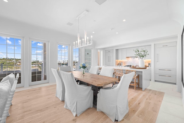 dining space with a chandelier and light hardwood / wood-style floors