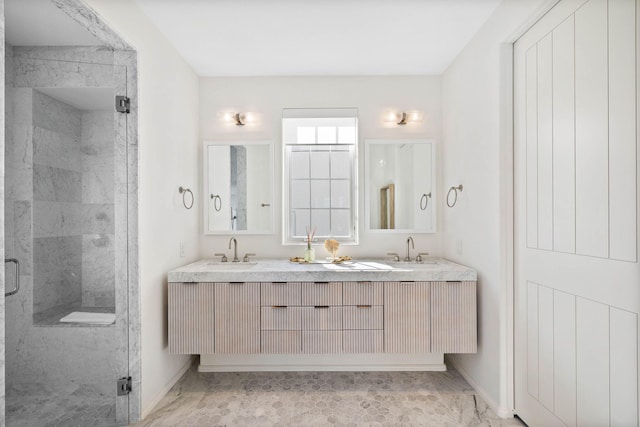 bathroom featuring vanity and a shower with shower door