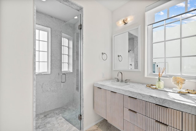 bathroom featuring vanity and a shower with shower door