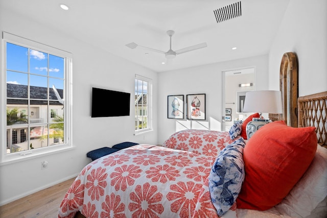 bedroom with ceiling fan and light hardwood / wood-style flooring