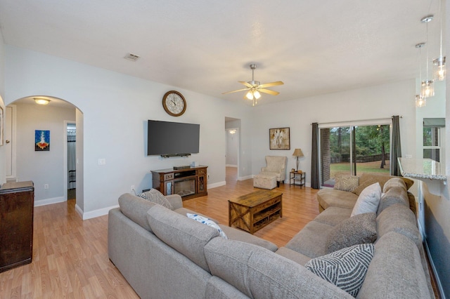 living room featuring light hardwood / wood-style floors and ceiling fan