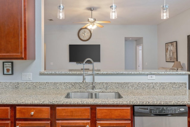 kitchen featuring pendant lighting, sink, stainless steel dishwasher, ceiling fan, and light stone counters