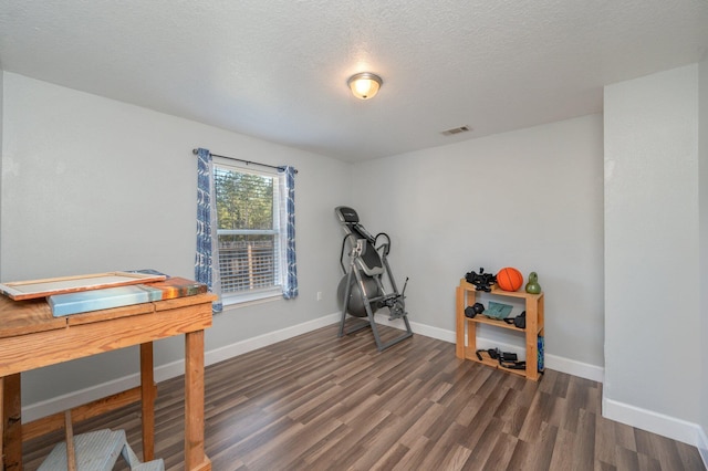 interior space featuring dark hardwood / wood-style floors and a textured ceiling