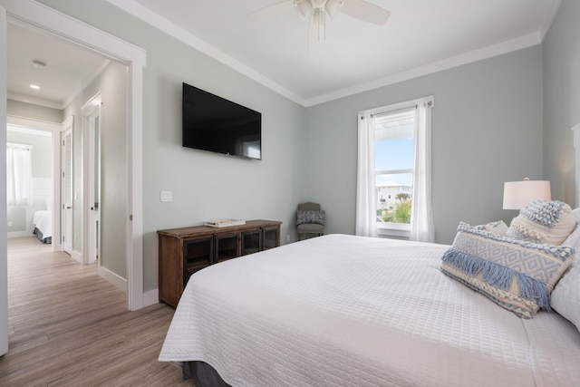 bedroom featuring ornamental molding, light hardwood / wood-style floors, and ceiling fan