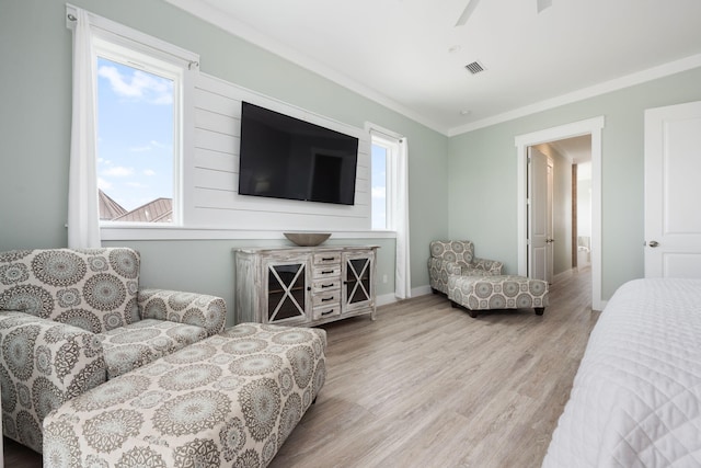 interior space featuring light hardwood / wood-style flooring, ornamental molding, and ceiling fan