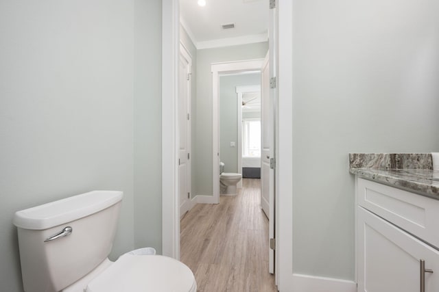 bathroom featuring hardwood / wood-style flooring, vanity, and toilet