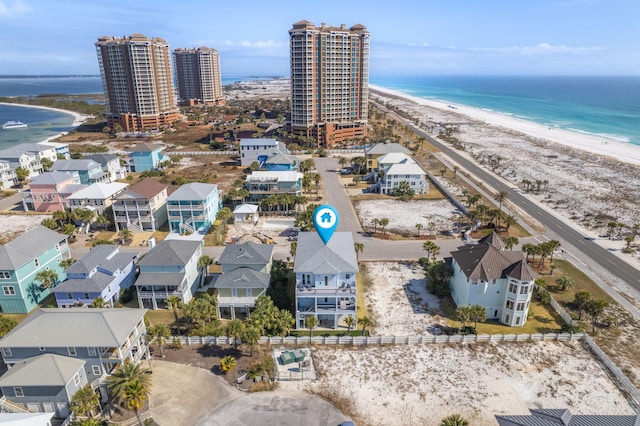 bird's eye view featuring a water view and a beach view