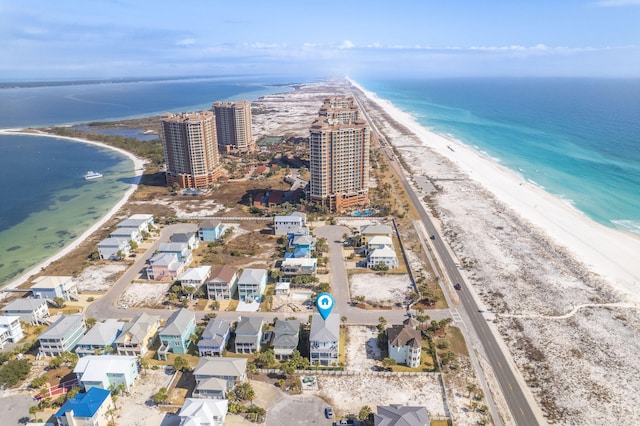 aerial view with a water view and a beach view