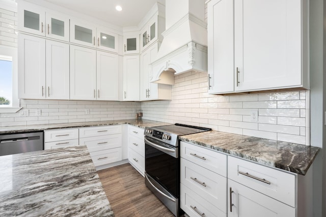 kitchen featuring white cabinetry, light stone countertops, custom exhaust hood, and stainless steel appliances