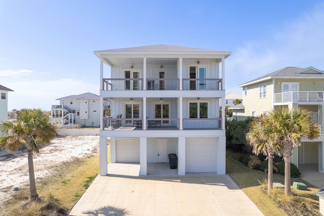 raised beach house with a garage and a balcony