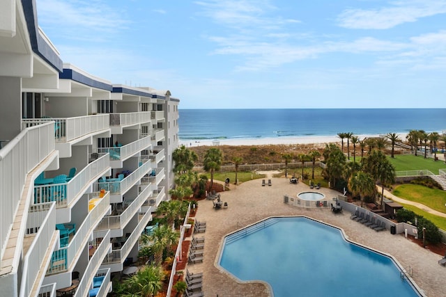 view of swimming pool featuring a beach view and a water view