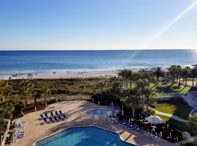 exterior space featuring a water view and a view of the beach